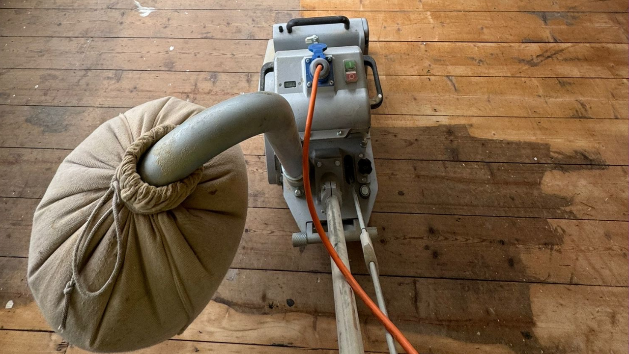 Sanding in progress on heritage pine floorboards in a Catford property using expert wood floor sanding equipment.