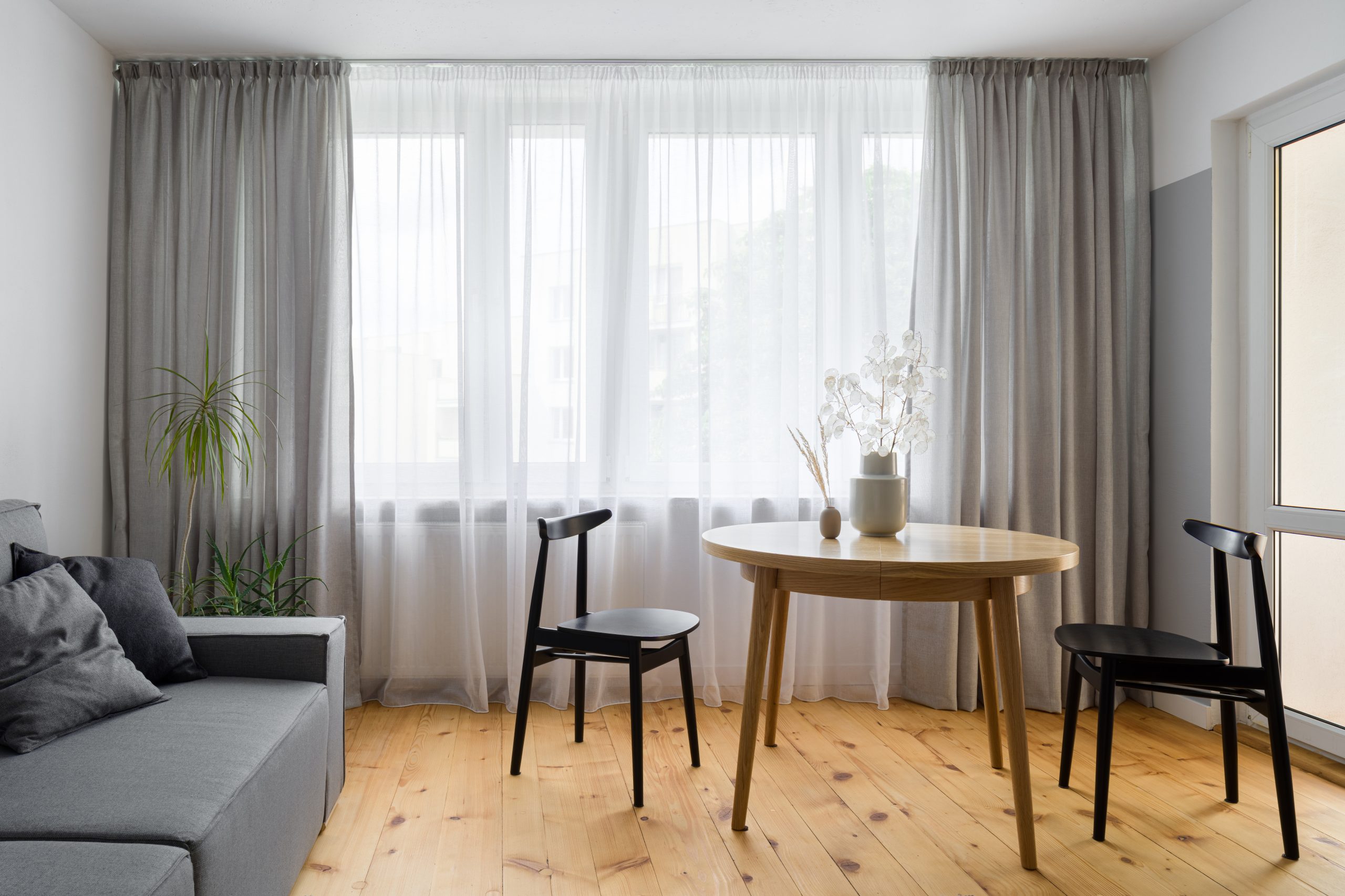 Bright Catford living room with softwood floors professionally restored by expert wood floor sanding.