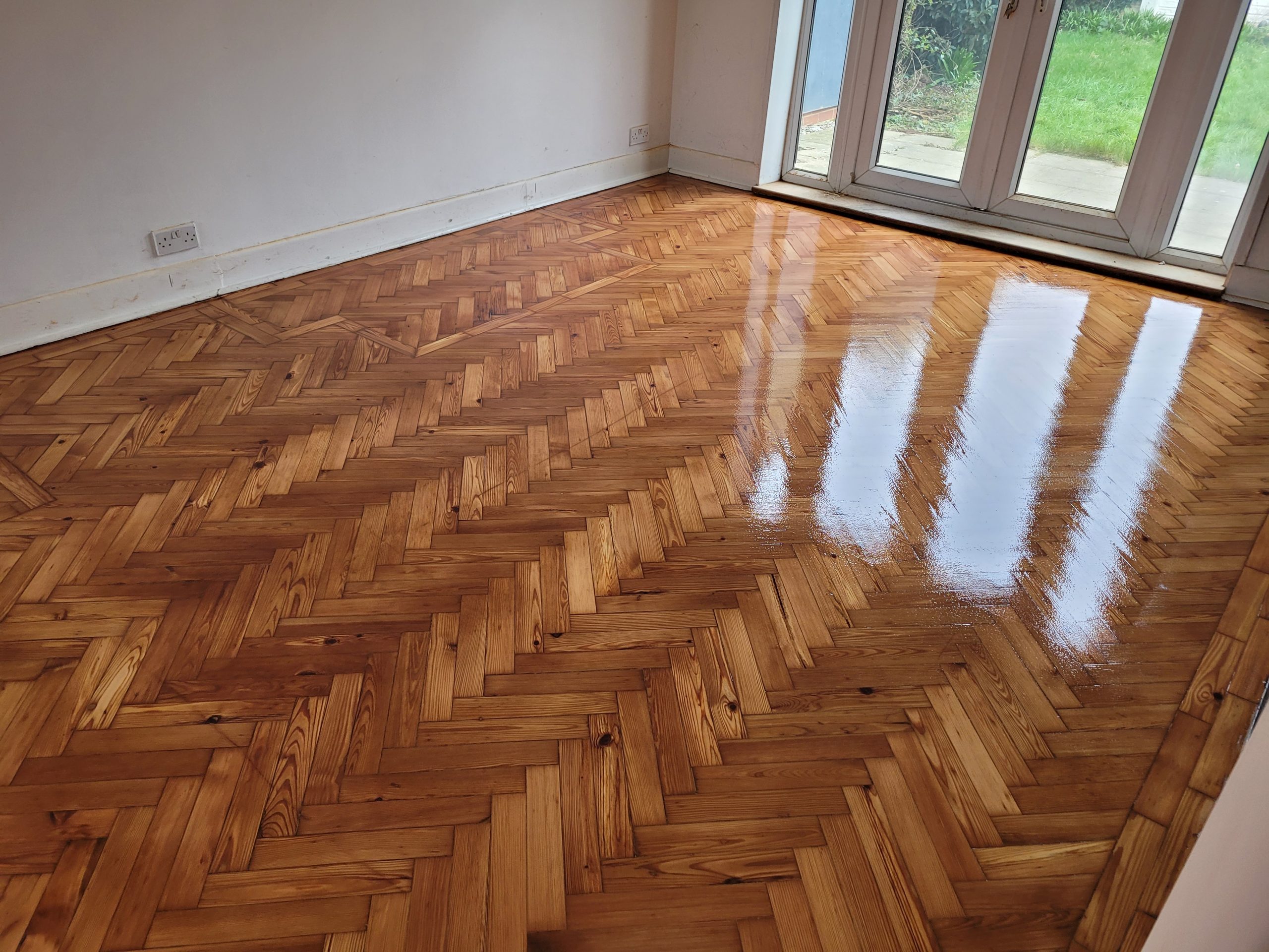 Restored and polished herringbone parquet flooring after Professional Wood Floor Sanding in a Catford home.