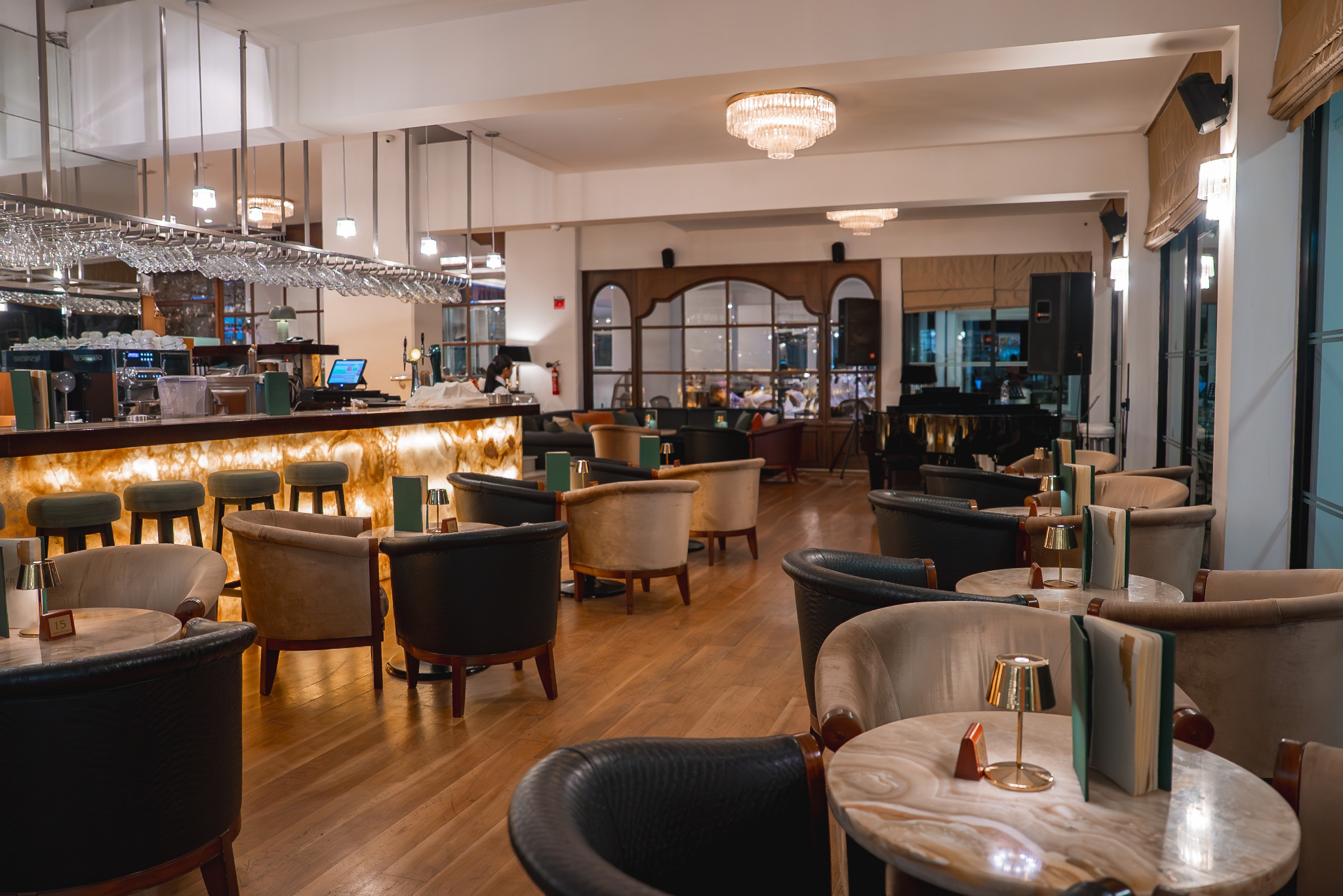 Pub Refurbs in Catford – upscale lounge bar with light-oak plank flooring (engineered wood, matt-lacquered), onyx-lit bar, club chairs and chandeliers.