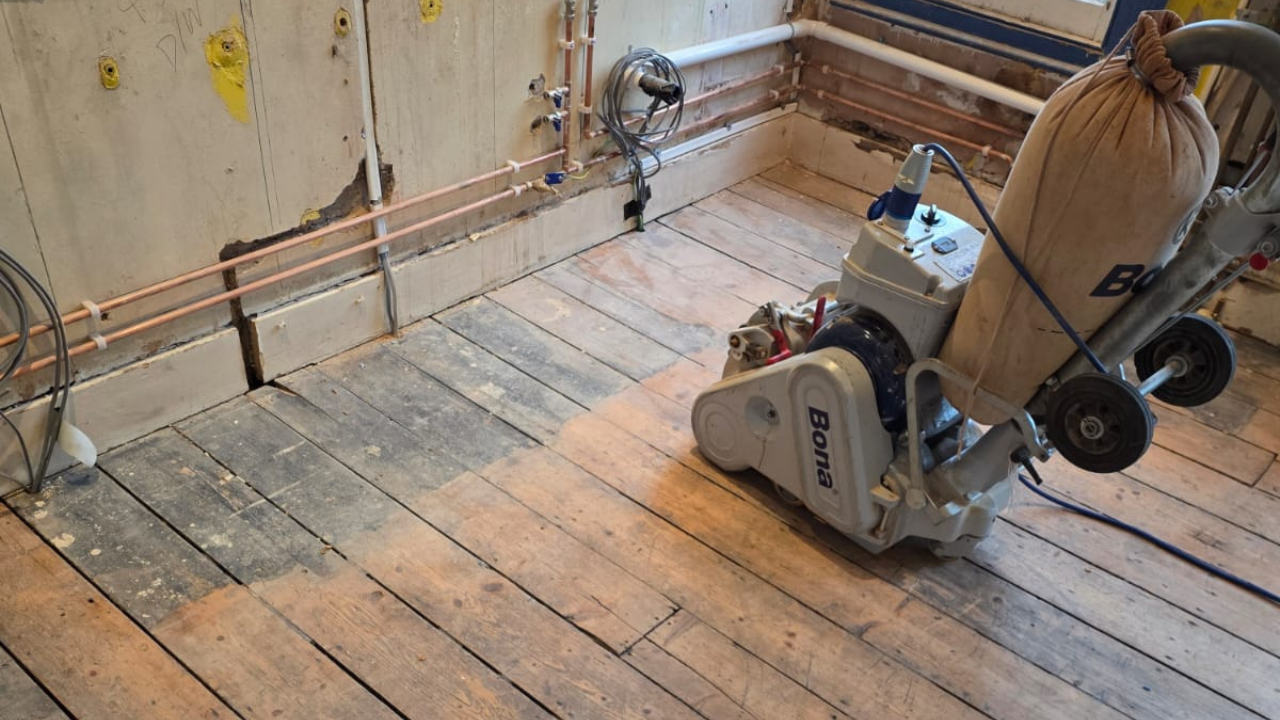 Wood Floor Sanding in Catford on original pine floorboards using a professional Bona drum sander during restoration work.