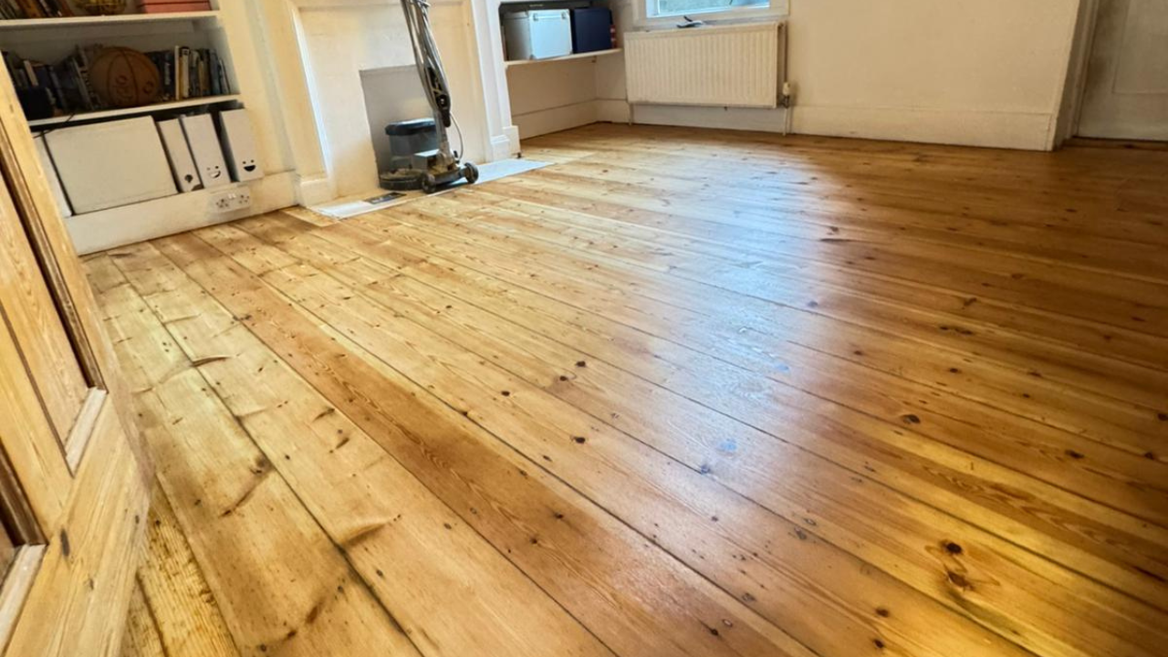 Wood Floor Sanding in Catford on restored solid pine floorboards in a bright living room.