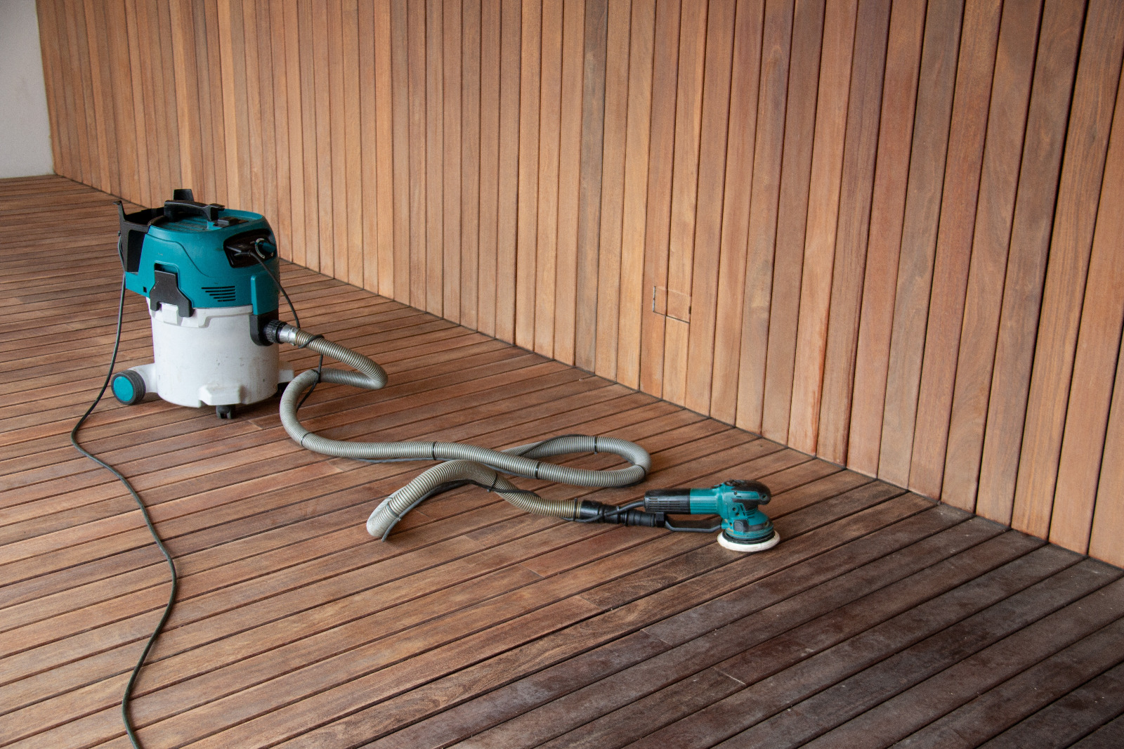Dust-free Deck Sanding and Renewal in Catford on hardwood timber decking floor, with professional sanding equipment ready on a freshly prepared garden deck.