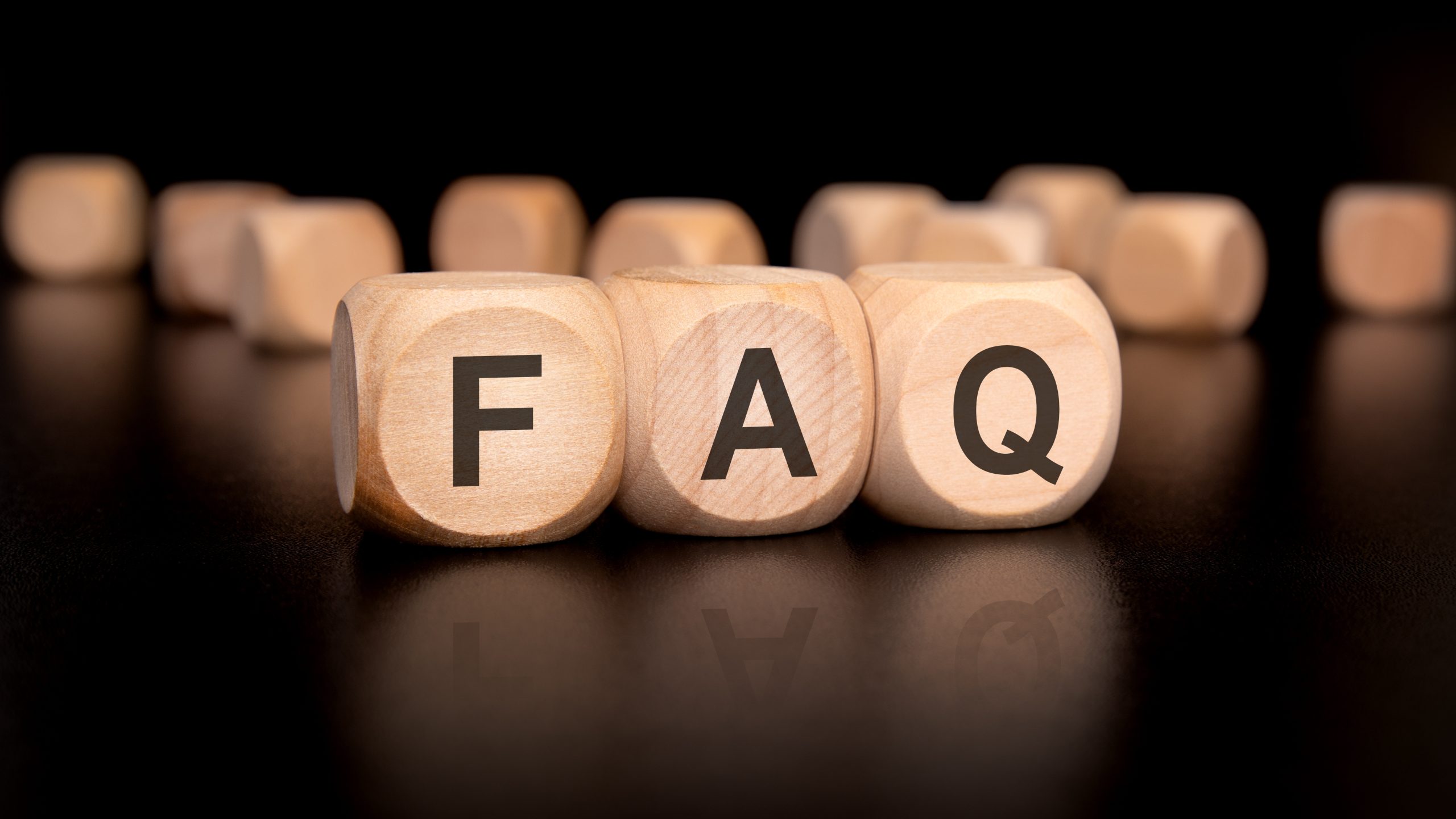 FAQ about Deck Sanding and Renewal in Catford for timber garden decking floors, represented by wooden blocks spelling the letters F A Q on a dark background.