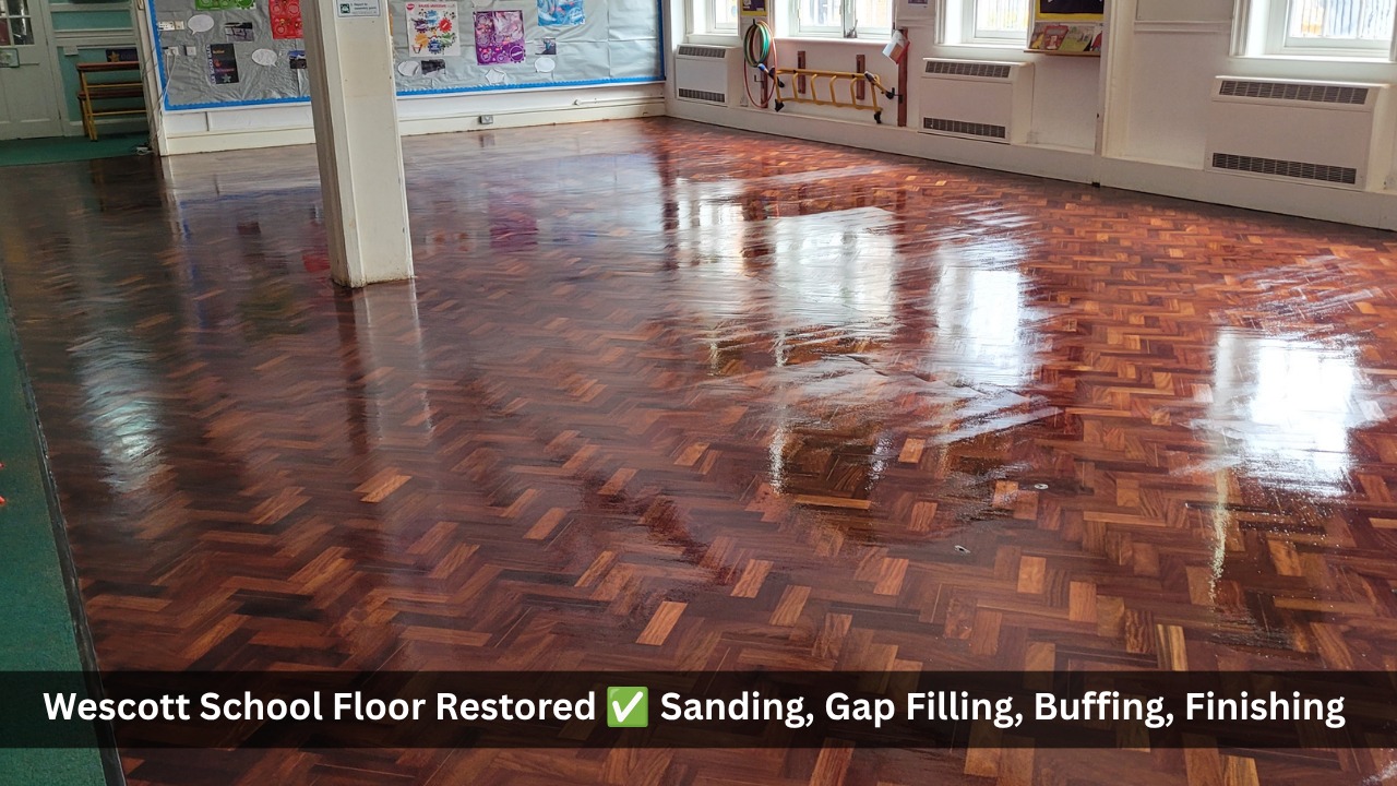 Restored herringbone parquet floor in a school hall after professional sanding, gap filling, buffing and finishing with a high-gloss protective seal